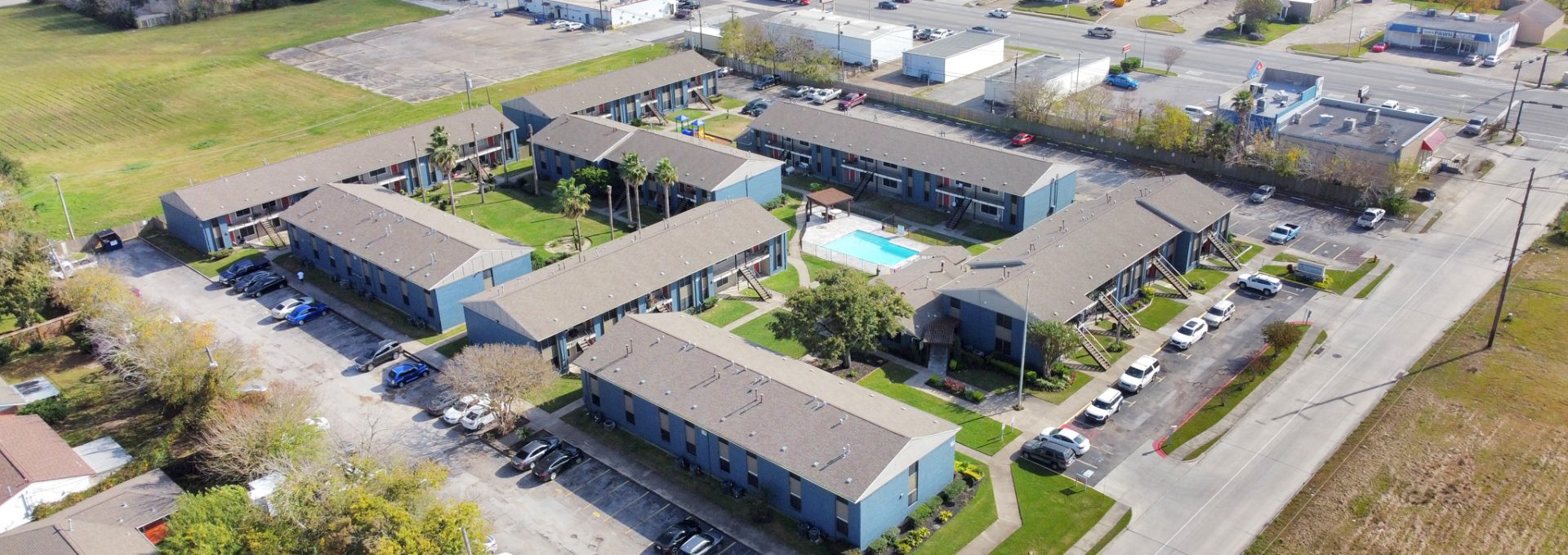 an aerial view of a residential complex with a parking lot at The  Crossings at 31st