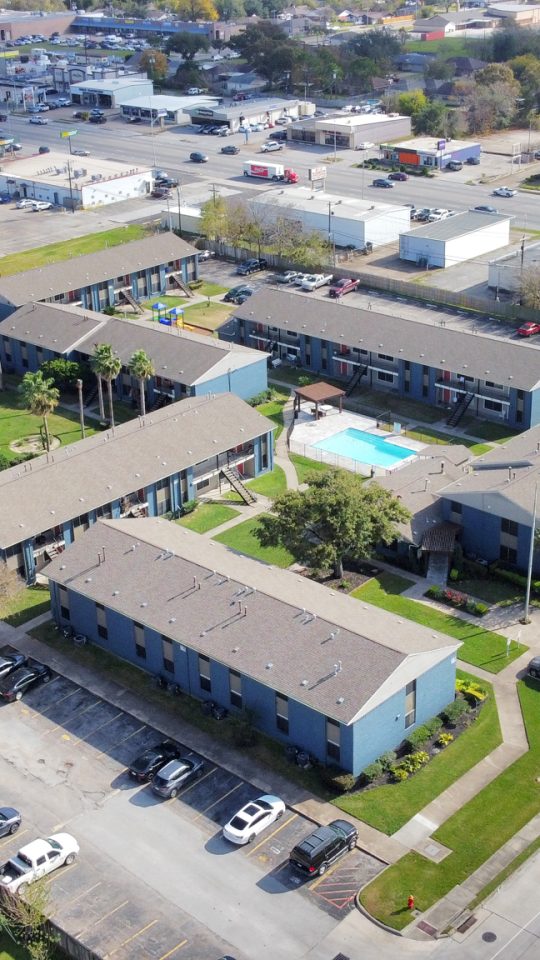an aerial view of a residential complex with a parking lot at The  Crossings at 31st