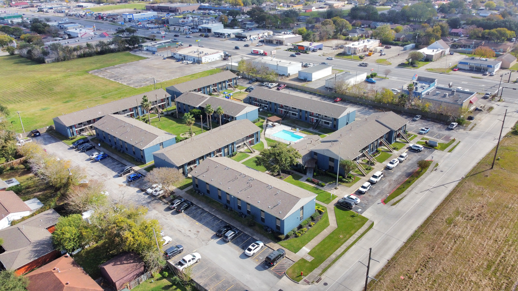 an aerial view of a residential complex with a parking lot at The Crossings at 31st