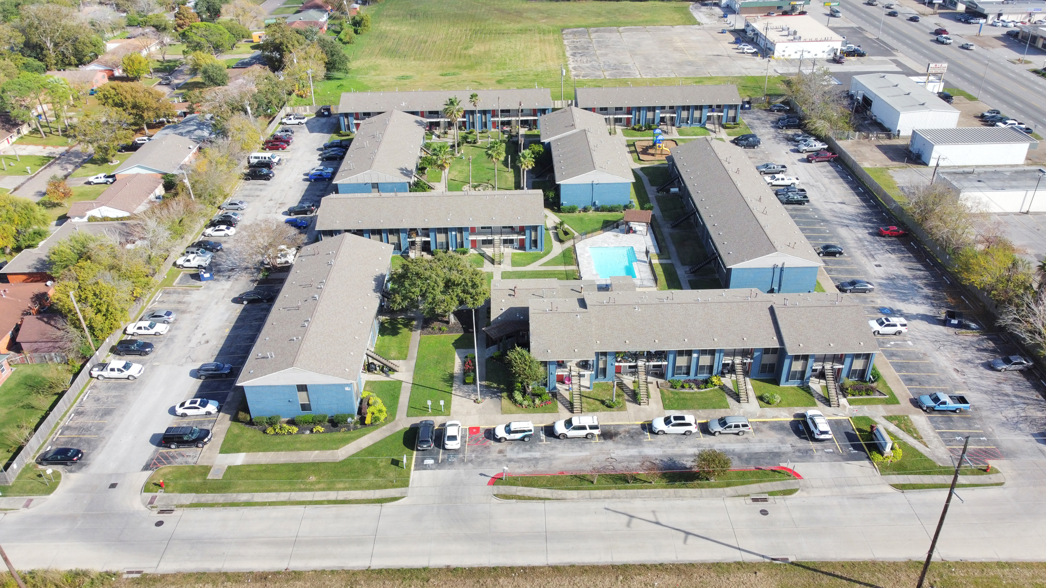 an aerial view of a residential complex with parking lots at The Crossings at 31st