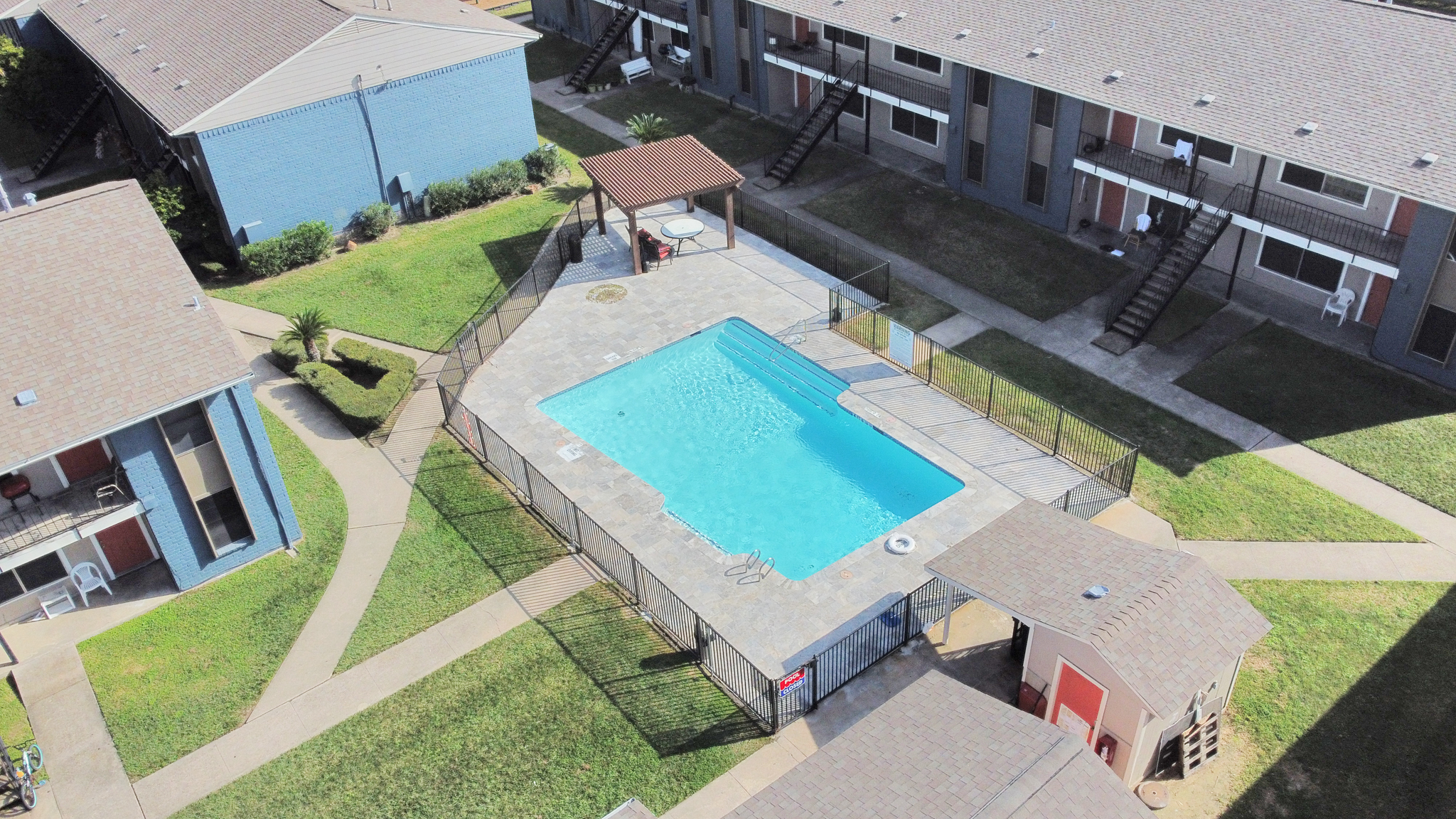 an aerial view of a pool and apartment complex at The Crossings at 31st