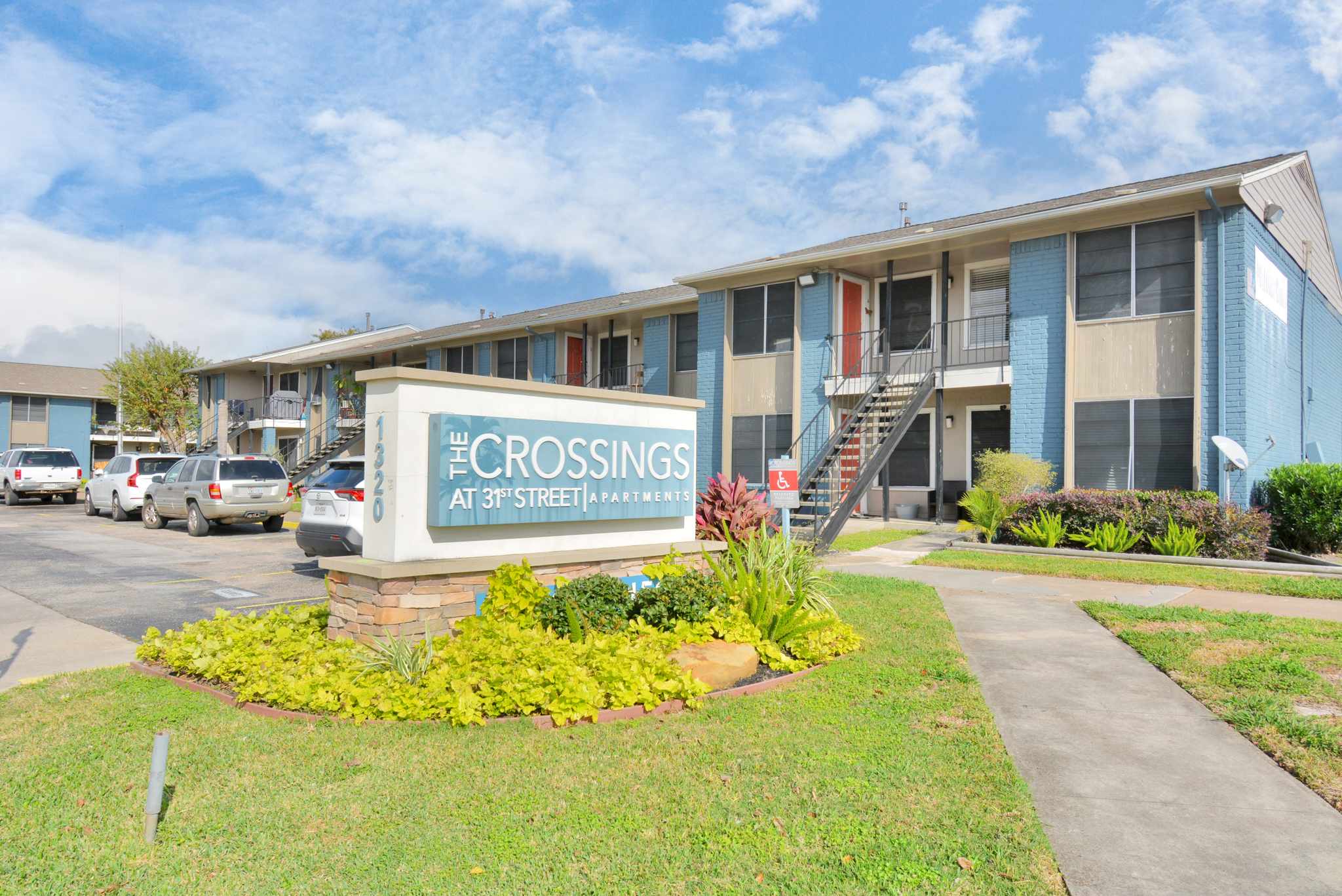 the sign for the apartment complex at The Crossings at 31st