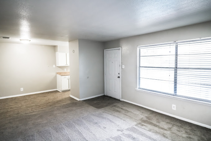 empty room with carpet and light gray walls at The Crossings at 31st