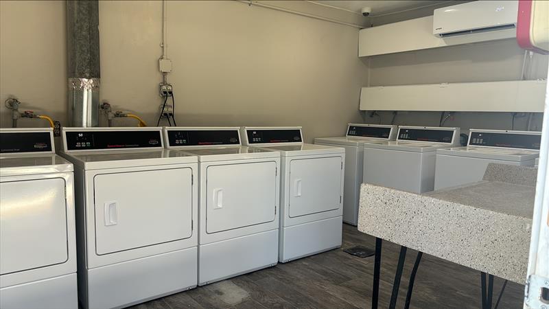 a laundry room with washers and dryers in it at The Crossings at 31st